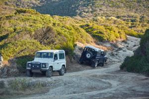 Two jeeps pointed in opposite directions on a mountainside