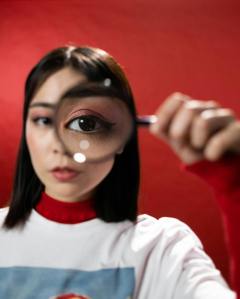 Woman looks through magnifying glass